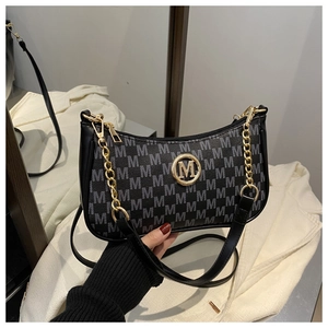 Detailed shot of half-moon bag with gray 'M' jacquard pattern and golden logo
