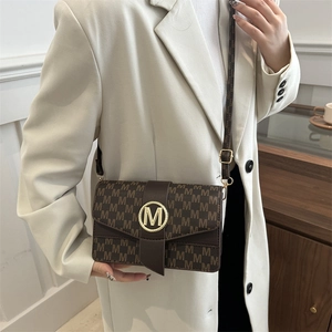 Brown faux leather crossbody bag with repeat M letter print and gold circular metal logo