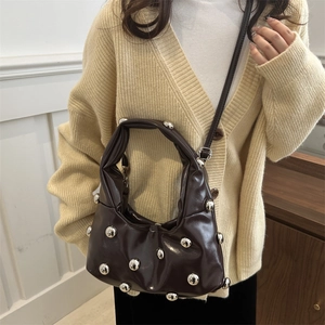 Brown patent leather rivet tote bag with silver studs and adjustable shoulder strap