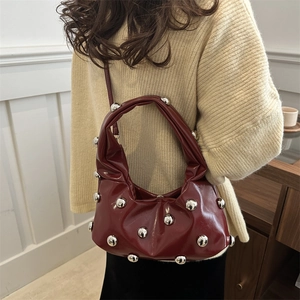 Minimalist burgundy crescent bag with silver stud accents and pleated leather design
