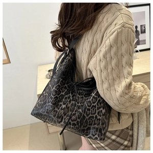 Detail of vintage leopard print tote bag with black drawstring and slim shoulder strap