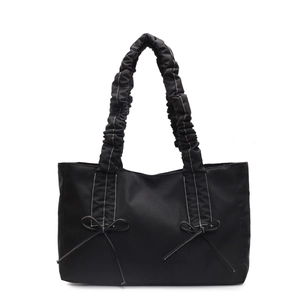 Black tote bag with bow detail, pleated handle and white contrast stitching for women