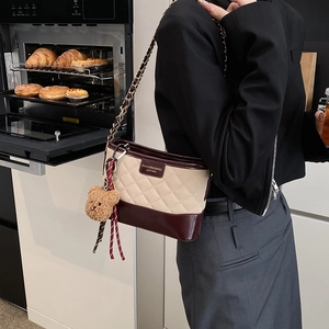 Sac seau matelassé bicolore crème et bordeaux avec bandoulière et pendentif ours