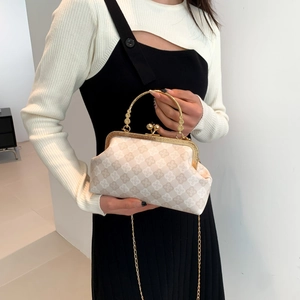 Fashionable shell-shaped tote bag with vintage monogram pattern and gold metal handle