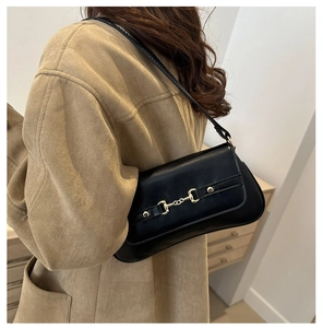Detail showing high-quality black PU leather texture with gold horsebit metal buckle