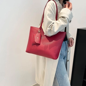Red lychee textured leather tote bag with matching coin purse and minimalist design