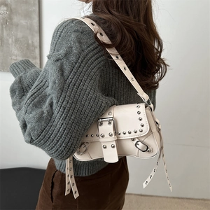Minimalist cream shoulder bag with silver studs and Y2K punk style design
