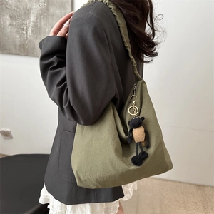 Olive green nylon tote bag for students with a cute sheep plush charm on the shoulder strap