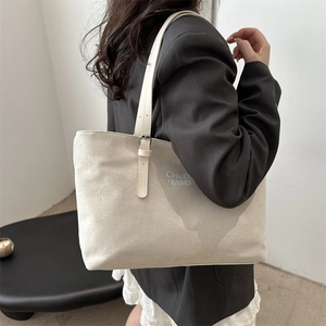 Minimalist beige suede tote bag with adjustable strap and text print for women
