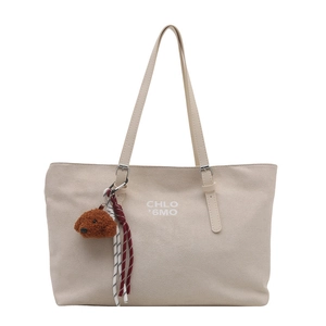 Minimalist beige tote bag with CHLO '6MO print and brown bear charm on white background
