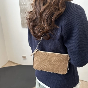 Khaki crocodile pattern crossbody bag with silver metal studs and thin chain strap