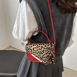 Leopard print crossbody bag in vibrant red faux leather with gold trim on shoulder