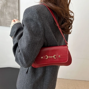 Retro red square shoulder bag with gold horsebit hardware shown on a female model