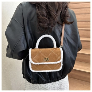 Detailed view of vintage crossbody bag with brown suede texture and faux fur trim details