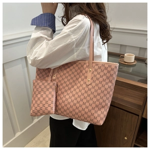 Detail of pink-orange tote bag set with M-letter prints and small matching pouch