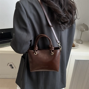 Chic dark brown vintage leather bucket bag with top handle and crossbody strap