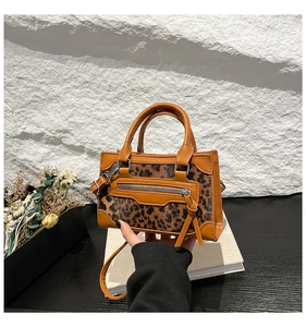 Mini leopard print tote bag with orange leather trim and silver metal hardware details