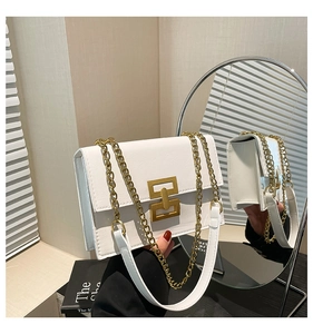 Close-up of white PU leather square bag with gold geometric buckle and chain strap
