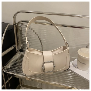 Macro shot of minimalist cream-white baguette bag with silver square metal buckle