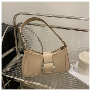 Detail of minimalist beige baguette bag with large silver buckle on modern display
