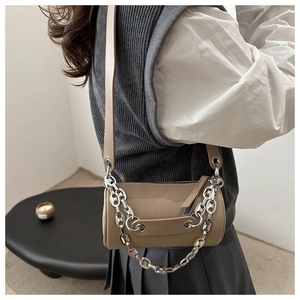 Detail of khaki cylinder crossbody bag with chunky silver chain and wide strap
