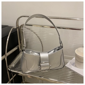 Detailed shot of metallic silver bag with oversized square buckle and leather strap