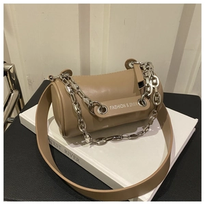 Detail of khaki cylinder bag featuring silver chain strap and fashion lettering logo