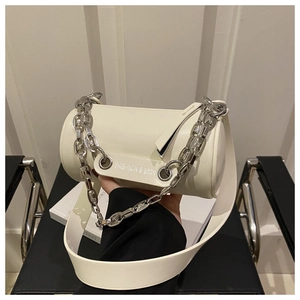 Detail of white cylinder bag with silver chunky chain and broad leather shoulder strap