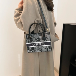 Fashionable crossbody square tote bag with botanical prints and black leather handles