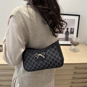 Classic black crescent moon shoulder bag with grey monogram print and gold bow detail
