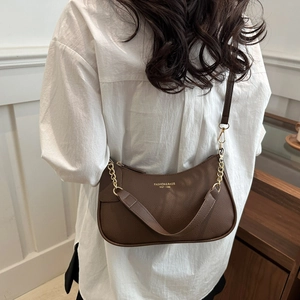 Brown lychee leather crescent shoulder bag with gold chain strap and branding