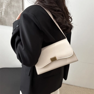 Minimalist cream white French baguette bag with gold lock buckle and vertical texture