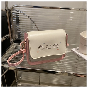 Detail of trendy small square crossbody bag with Poppy cartoon prints and cream flap