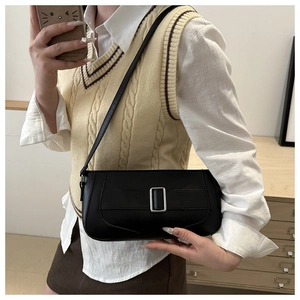 Detail of black leather crescent bag with silver buckle and adjustable shoulder strap