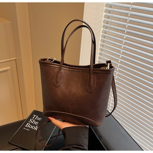 Close-up of a retro brown tote bag with leather texture and Fashion & Bags lettering