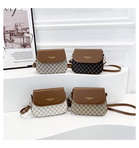 Detail view of four vintage saddle bags in various colors on a minimalist display