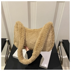 Close-up of soft beige plush faux fur shoulder bag with textured surface detail