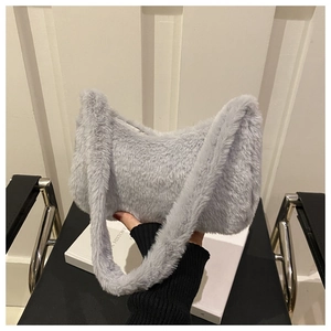 Close-up of fluffy light grey faux fur texture on a soft baguette shoulder bag