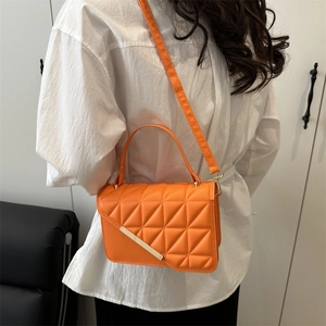 Bright orange quilted crossbody bag for women with triangular texture and golden detail
