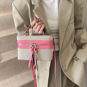 Chic beige canvas box bag with pink leather trim and dual zippers for 2025 spring trends