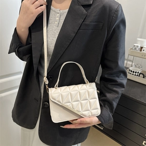 White quilted crossbody bag with gold metal trim and adjustable strap for women
