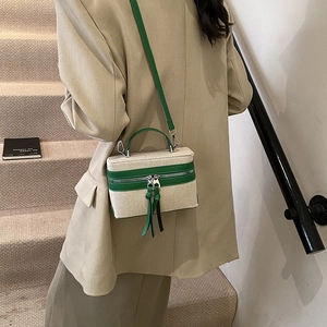 Minimalist cream canvas crossbody bag with green leather trim and stylish tassels