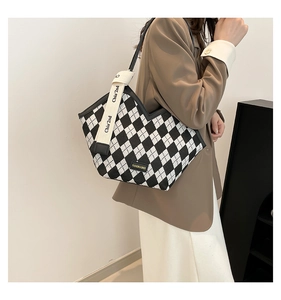 Macro shot of checkered canvas tote bag with V-cut opening and fashion logo detail