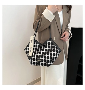 Detail of tweed tote bag featuring chic houndstooth pattern and elegant silk scarf accent