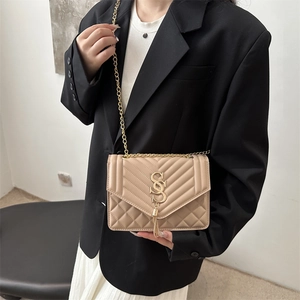 Chic beige quilted chain shoulder bag with V-shaped stitching and tassel charm pendant