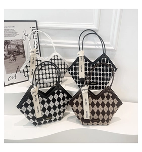 Detailed display of four patterned tote bags with unique V-shaped openings and ribbons