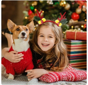 Close-up of a festive Christmas headband with reindeer antlers on a smiling girl