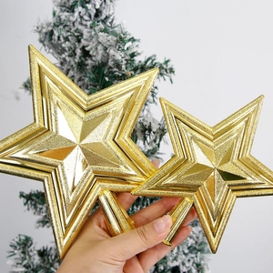 Golden 3D star tree topper set with shiny finish on a snowy Christmas tree background