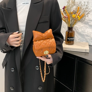 Quilted brown leather small crossbody bag with large bow and gold metal clasp chain