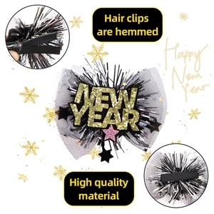 Detail view of New Year hair clip with gold glitter letters and black mesh on duckbill clip